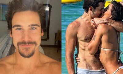 Na praia e de traje de banho transparente Nicolas Prattes